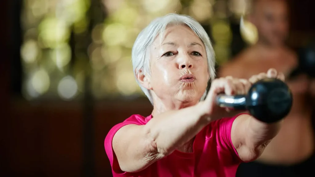 Toning Arms Without the Bulk: Is It Achievable? 1 Woman doing resistance band exercises for toned arms Leighton Buzzard